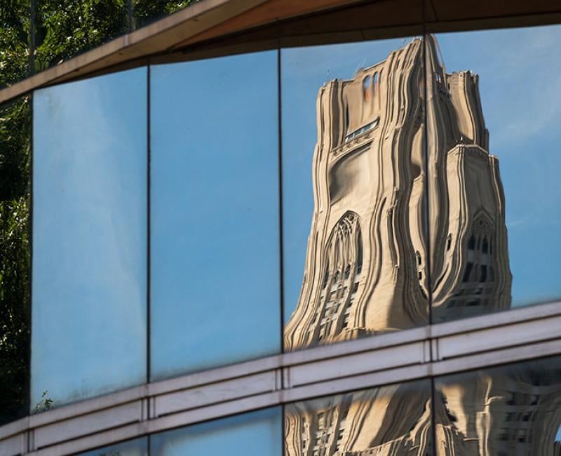 The Cathedral of Learning, distorted and reflected in glass.