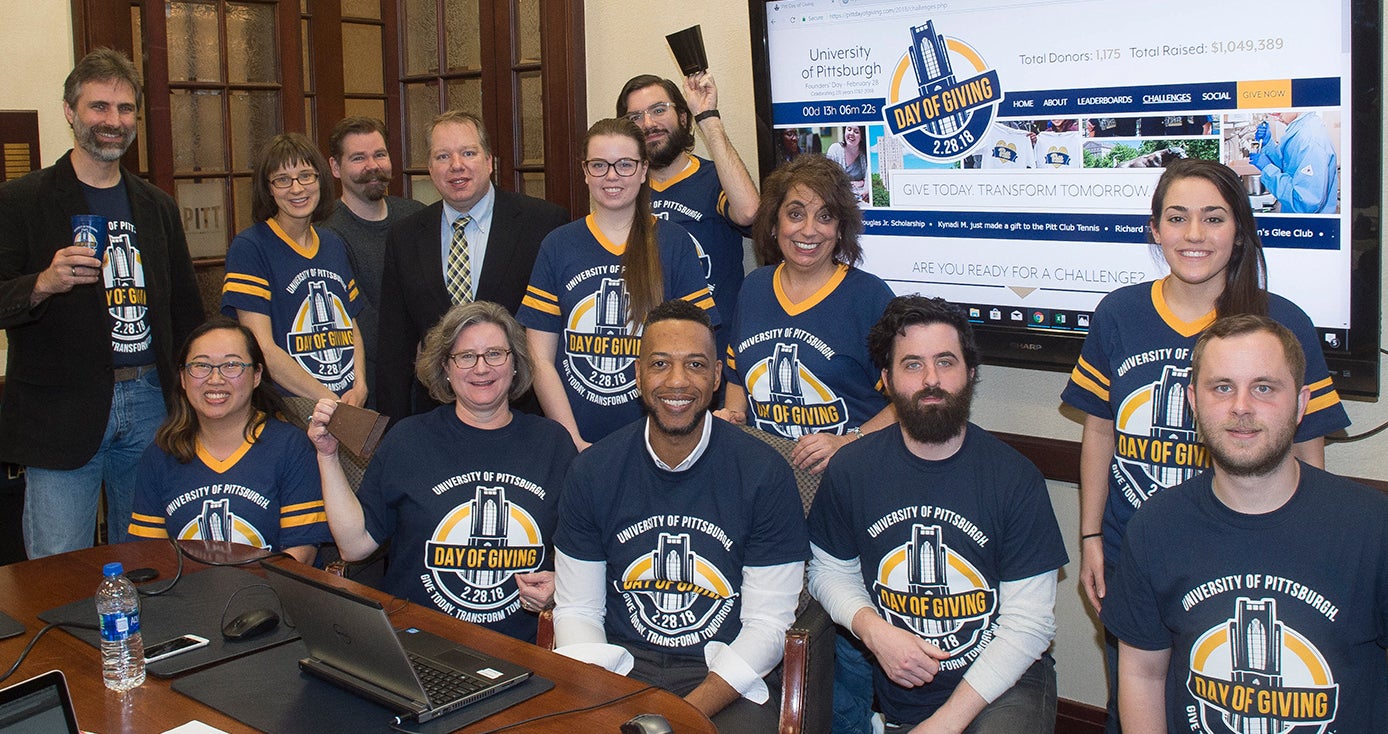a group of Pitt staffers wearing Day of Giving T-shirts