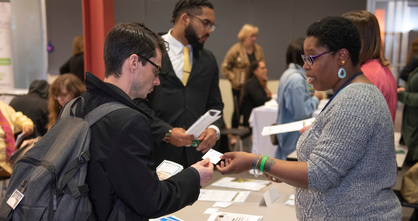 Local entrepreneur Jeremy Burnworth (left) accepts advice from LaMonica Wiggins on his plan for an incubator to help entrepreneurs who have a criminal background. Wiggins was staffing a table at a recent Small Business Resource Fair in Squirrel Hill. 