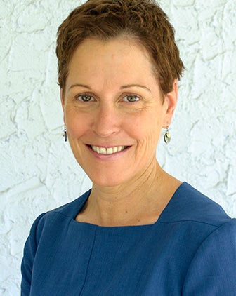 Davitt, a woman with short brownish hair and wearing a blue shirt