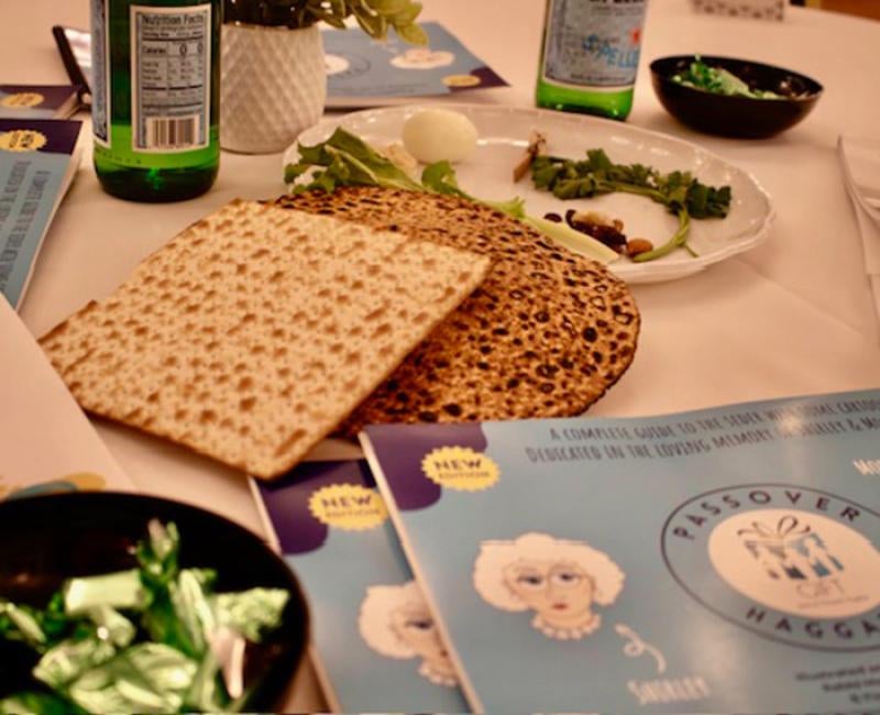 Matzo crackers on a plate with literature on Passover