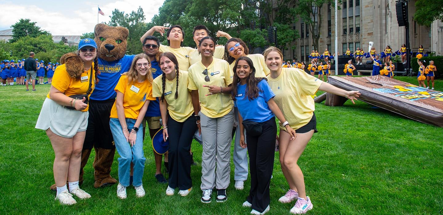 Students pose with Roc on Cathedral Lawn