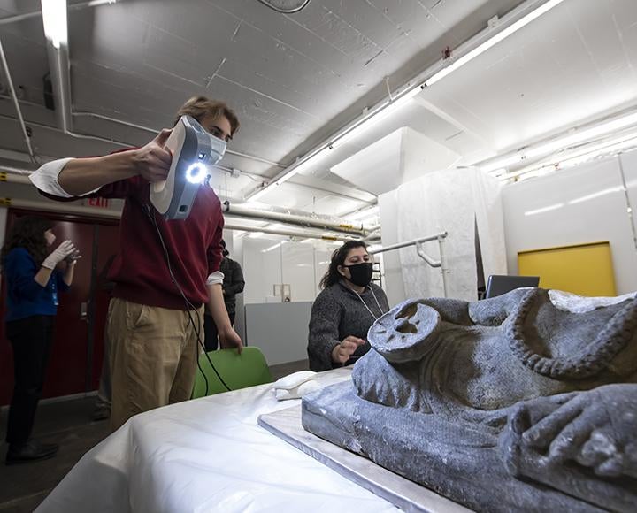 Derek Wessel and Brianna Stellini scanning a Etruscan funerary statue