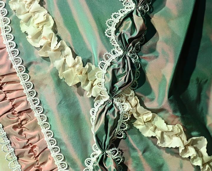 Trim on the dress' outer petticoat