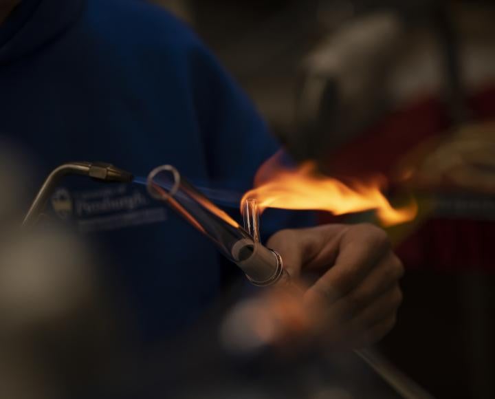 Ryan Tate heats up a piece of glass with a blowtorch