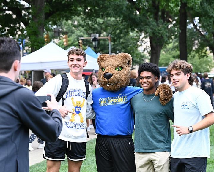 Three people pose for a picture with ROC