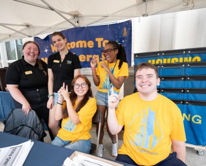 Student volunteers gestured outside Nordenberg Hall