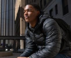 Xavier Littlejohn on the Pitt campus in a black jacket