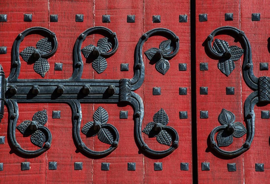 Red door with wrought iron decoration.