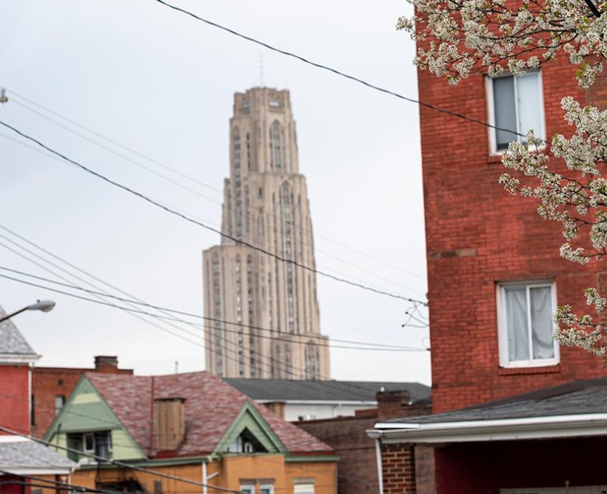 The Cathedral of Learning seen behind houses in the Oakland neighborhood