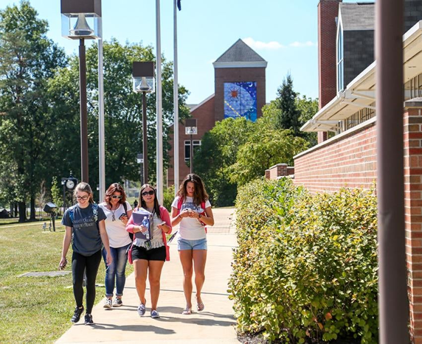 A group of students walk on Pitt-Greensburg's campus