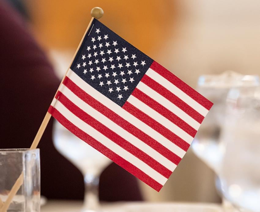 A small American flag in a glass