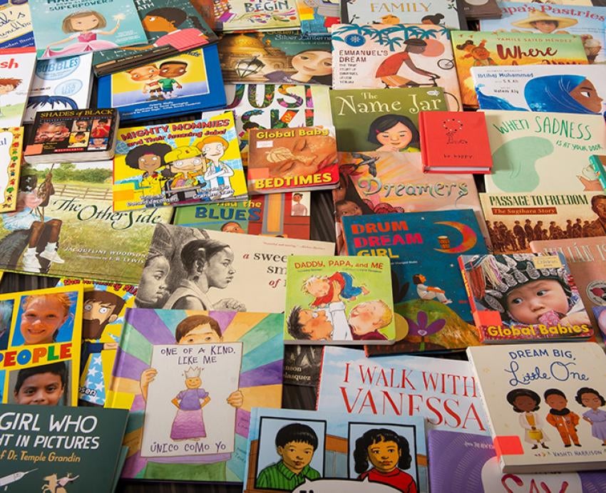 Children's books piled on a table