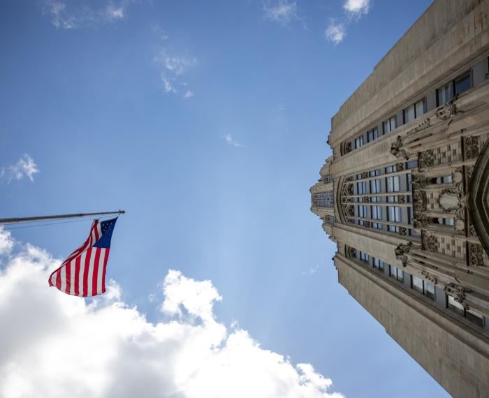 a view from the ground near the Cathedral with a flag on the left and building on the right