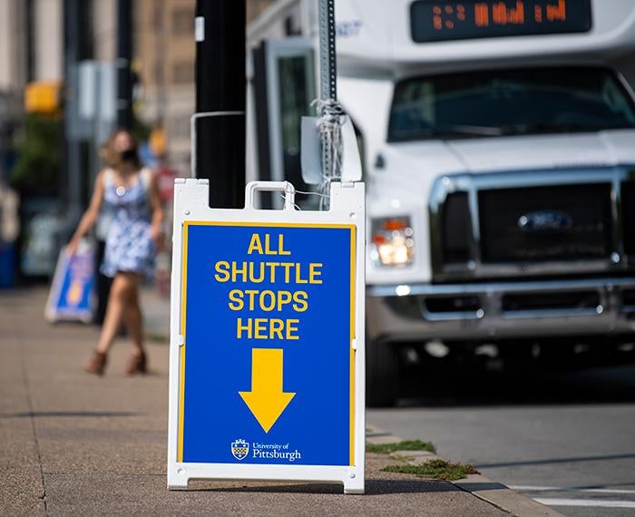 An A-frame sign reads All Shuttle Stops Here