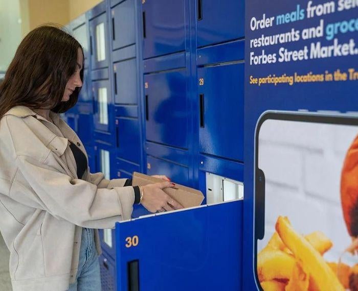 A student grabs an item from the Pitt Pantry lockers.